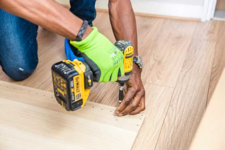 man drilling wood